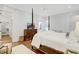 Comfortable main bedroom with hardwood floors, shiplap walls, and a view to the ensuite bathroom at 27 22Nd Ave, Isle of Palms, SC 29451