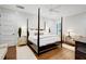Elegant main bedroom with a four-poster bed, hardwood floors, and white shiplap walls at 27 22Nd Ave, Isle of Palms, SC 29451