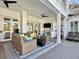 Spacious outdoor living area with comfortable seating, TV, and outdoor kitchen for entertaining at 27 22Nd Ave, Isle of Palms, SC 29451
