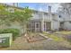 Exterior view of back of home with screened porches and landscaping at 2765 Jobee Dr # 1304, Charleston, SC 29414