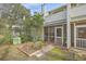 Exterior view of back of home with screened porches and landscaping at 2765 Jobee Dr # 1304, Charleston, SC 29414