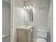 Neutral bathroom with a vanity, toilet, and decorative mirror under modern lighting at 2765 Jobee Dr # 1304, Charleston, SC 29414
