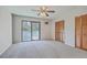 Spacious bedroom with balcony access, ceiling fan, and ample closet space at 2765 Jobee Dr # 1304, Charleston, SC 29414
