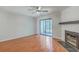 Bright living room with hardwood floors, fireplace, ceiling fan, and sliding glass doors at 2765 Jobee Dr # 1304, Charleston, SC 29414