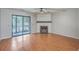 Bright living room with hardwood floors, ceiling fan, fireplace, and sliding door to an outdoor space at 2765 Jobee Dr # 1304, Charleston, SC 29414