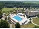 Aerial view of the community pool, lounging area, and lush green surroundings, creating a resort-like feel for residents at 2784 Hidden Oak Dr, Seabrook Island, SC 29455
