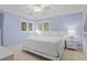 Relaxing blue bedroom featuring natural light, a king-size bed, and white bedside tables at 2784 Hidden Oak Dr, Seabrook Island, SC 29455