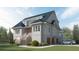Spacious three-story home with a gray exterior, white trim, and a well-manicured lawn at 2784 Hidden Oak Dr, Seabrook Island, SC 29455