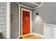 Inviting entryway with a vibrant red door and weathered wood plank walls at 2784 Hidden Oak Dr, Seabrook Island, SC 29455