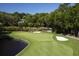 Golf course with a water feature and mature trees around the perimeter creates a tranquil environment at 2784 Hidden Oak Dr, Seabrook Island, SC 29455