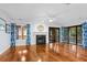 Bright living room with hardwood floors, fireplace, and sliding doors to the balcony at 2784 Hidden Oak Dr, Seabrook Island, SC 29455
