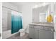 Bright bathroom featuring granite countertops, gray cabinetry, and a combined shower and bathtub at 2942 Clearwater Dr, Mount Pleasant, SC 29466