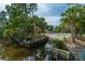 Concrete boat ramp between wooden retaining walls, surrounded by palms and lush foliage at 2942 Clearwater Dr, Mount Pleasant, SC 29466
