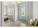 Bright entryway with light wood floors, white walls, and a stylish aqua colored door at 2942 Clearwater Dr, Mount Pleasant, SC 29466