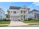 Inviting two-story home with a double front porch, white columns, a well-manicured lawn and a two car garage at 2942 Clearwater Dr, Mount Pleasant, SC 29466