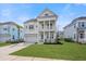Inviting two-story home with a double front porch, white columns, a well-manicured lawn and a two car garage at 2942 Clearwater Dr, Mount Pleasant, SC 29466