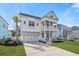Inviting two-story home with a double front porch, white columns, a well-manicured lawn and a two car garage at 2942 Clearwater Dr, Mount Pleasant, SC 29466