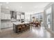 Bright, open kitchen with white cabinets, gray island with seating, and hardwood floors at 2942 Clearwater Dr, Mount Pleasant, SC 29466