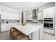 Spacious kitchen island features white countertop and seating for four, perfect for entertaining at 2942 Clearwater Dr, Mount Pleasant, SC 29466