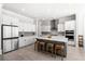 Well-lit kitchen boasts stainless steel appliances, white cabinets, and gray subway tile backsplash at 2942 Clearwater Dr, Mount Pleasant, SC 29466