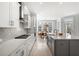 Open concept kitchen with white cabinets, a large island, and a breakfast nook overlooking the yard at 2942 Clearwater Dr, Mount Pleasant, SC 29466