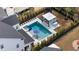 Aerial view of a sparkling pool with spa, lounge chairs, and a covered patio area surrounded by a landscaped backyard at 2942 Clearwater Dr, Mount Pleasant, SC 29466