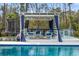 Poolside cabana with TV, comfortable seating and blue privacy curtains at 2942 Clearwater Dr, Mount Pleasant, SC 29466