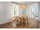 Bright dining room with natural light, dining table with six chairs and modern chandelier at 305 Pine Crest View Dr, Summerville, SC 29486