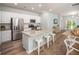 Bright kitchen boasts granite countertops, stainless steel appliances, and an island with bar seating at 305 Pine Crest View Dr, Summerville, SC 29486