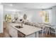 Open-concept kitchen with granite countertops, stainless steel sink, and views of the dining and living areas at 305 Pine Crest View Dr, Summerville, SC 29486