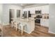 Modern kitchen featuring a granite island, stainless steel appliances, and white cabinetry at 305 Pine Crest View Dr, Summerville, SC 29486