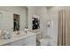 Bright bathroom featuring a white vanity, walk-in shower, and modern black-and-white artwork at 305 Tiliwa Street, Summerville, SC 29486