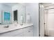 Well-lit bathroom featuring double sinks, a large mirror, and a separate toilet and shower area at 307 Tiliwa St, Summerville, SC 29486