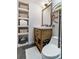 Charming bathroom with wood vanity, decorative mirror, modern toilet, built-in shelving, and tiled floor at 377 King St # 203, Charleston, SC 29401