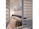 Comfortable bedroom with soft bedding, shutters, and wall art, creating a relaxing atmosphere at 377 King St # 203, Charleston, SC 29401