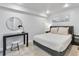 Bedroom features modern decor, carpeted floors, black desk and a beach painting at 377 King St # 203, Charleston, SC 29401