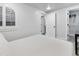 Bright, neutral bedroom boasts a closet, plenty of natural light, and a beach painting at 377 King St # 203, Charleston, SC 29401