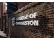 College of Charleston sign on a brick wall, showcasing its classic logo and font at 377 King St # 203, Charleston, SC 29401