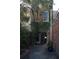 Exterior view of a building with lush greenery, gated entrance, and brick accents at 377 King St # 203, Charleston, SC 29401