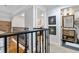 Upstairs hallway between bedrooms with hardwood floors, natural light and modern fixtures at 377 King St # 203, Charleston, SC 29401