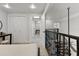 Hallway with views of the stairway, modern fixtures and doors to several rooms at 377 King St # 203, Charleston, SC 29401