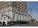 Historic hotel with arched windows, street level shops, and a view of the city church steeple at 377 King St # 203, Charleston, SC 29401