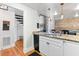 Open kitchen features granite countertops, stainless appliances, exposed brick and unique hanging lighting at 377 King St # 203, Charleston, SC 29401