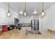 Bright kitchen with stainless appliances, granite counters and decorative lighting fixtures at 377 King St # 203, Charleston, SC 29401