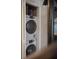 Efficient laundry closet featuring a stacked washer and dryer unit at 377 King St # 203, Charleston, SC 29401