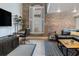 Inviting living room with exposed brick, comfortable seating, a stylish coffee table, and a view of the window at 377 King St # 203, Charleston, SC 29401
