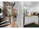 A cozy living room featuring hardwood floors, a spiral staircase, and a view into the kitchen with granite countertops at 377 King St # 203, Charleston, SC 29401