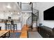 Stylish living space with a spiral staircase, white kitchen with granite countertops and stainless steel appliances at 377 King St # 203, Charleston, SC 29401