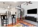 Living space with a spiral staircase, modern lighting, a breakfast bar, and a flat screen television at 377 King St # 203, Charleston, SC 29401