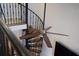 Spiral staircase featuring natural lighting, ceiling fan and a view of the black iron railing at 377 King St # 203, Charleston, SC 29401